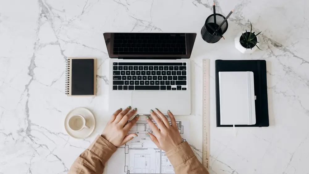 Website designer making edits to a website on a laptop