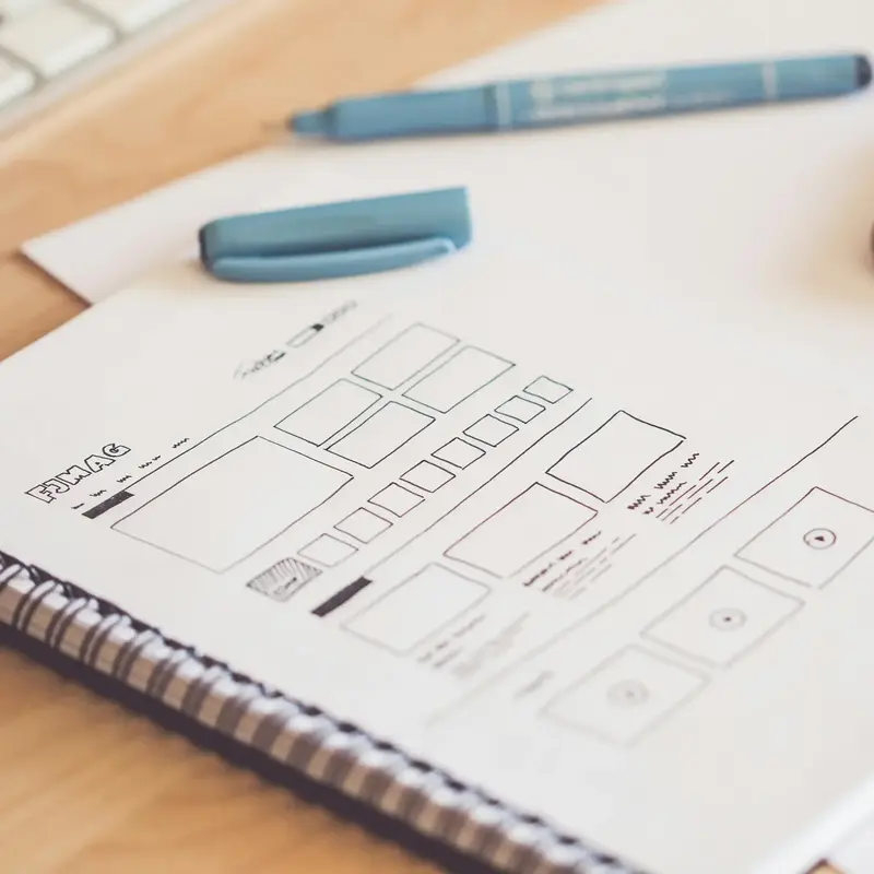 notebooke with hand-drawn web design wireframes